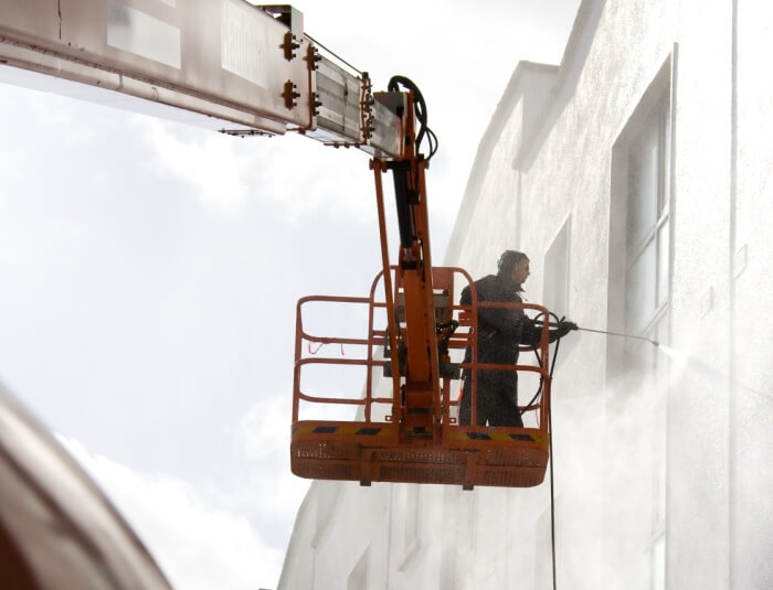 Power washing the outside of a commercial building