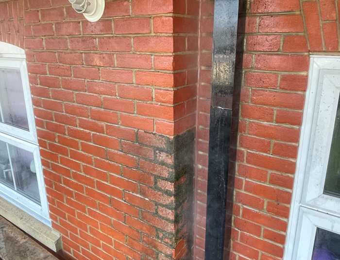 Before and after picture of jet washing a wall