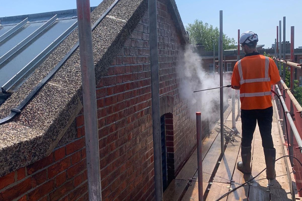 Power washing a brick building